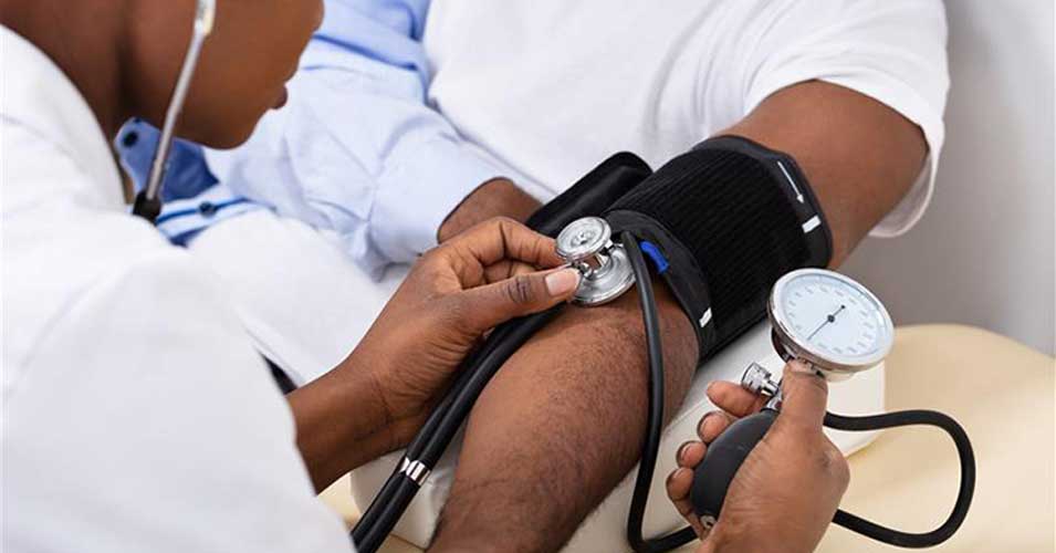 Provider checking a patient's blood pressure