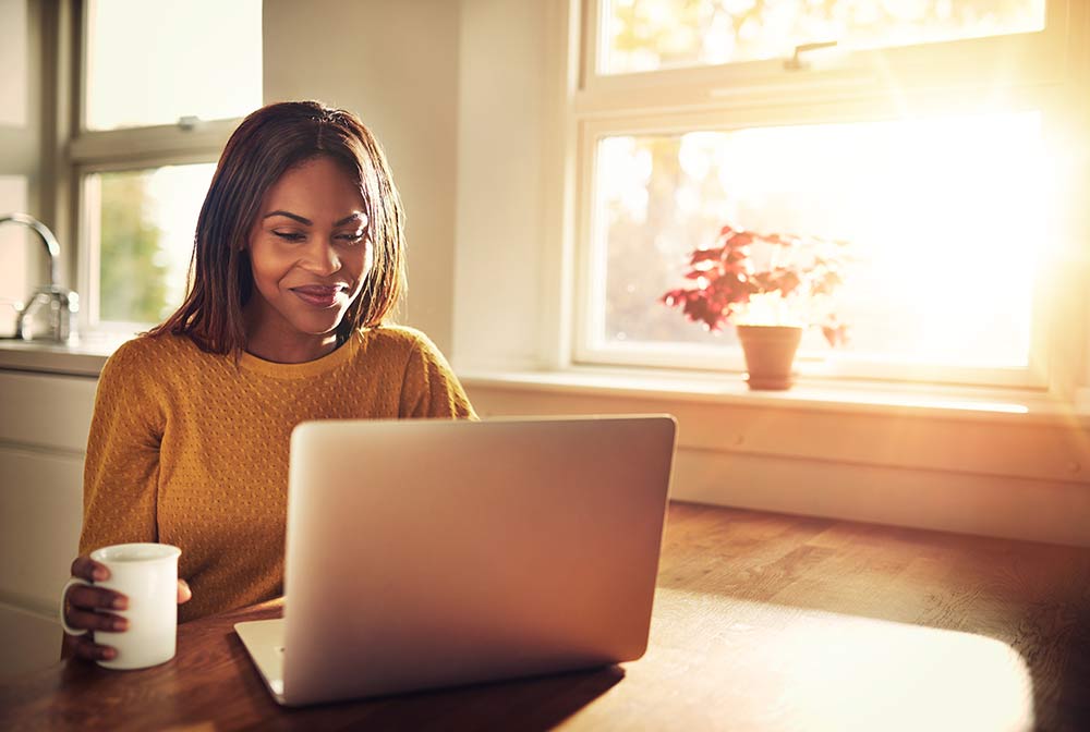 Smiling woman looking at laptop