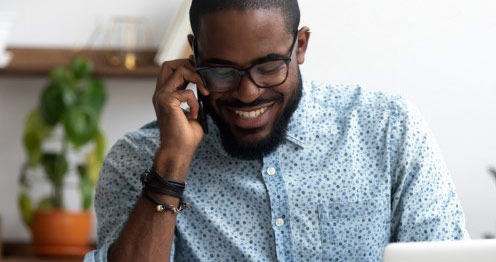 Smiling African American man talking on a mobile phone