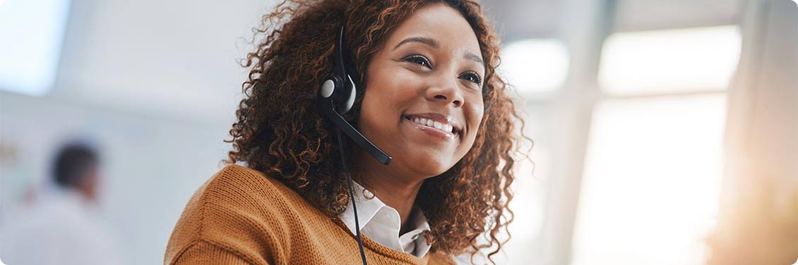 A smiling customer advocate wearing a headset